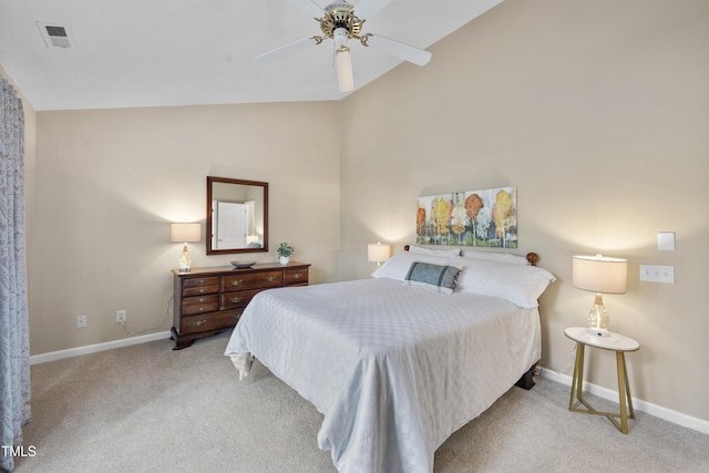 bedroom featuring baseboards, vaulted ceiling, and light colored carpet