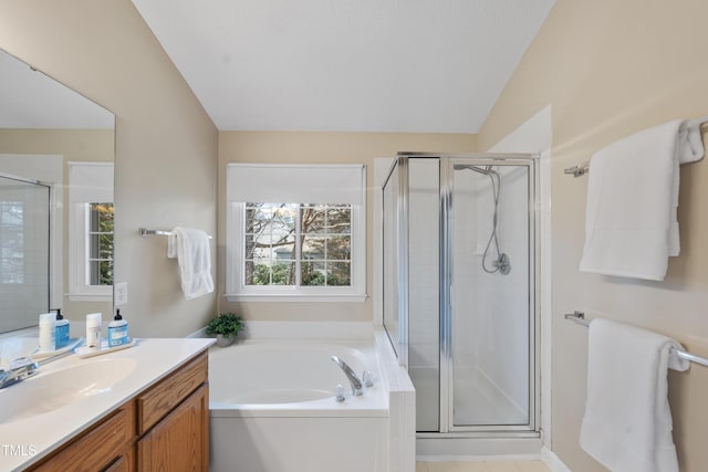 full bathroom featuring a stall shower, a bath, and vanity