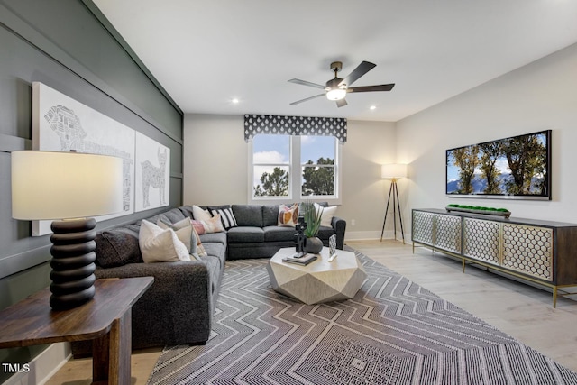 living room featuring ceiling fan and hardwood / wood-style floors