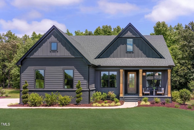 view of front of property with a front yard and covered porch