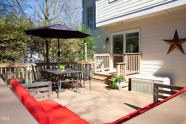 wooden terrace with outdoor dining space