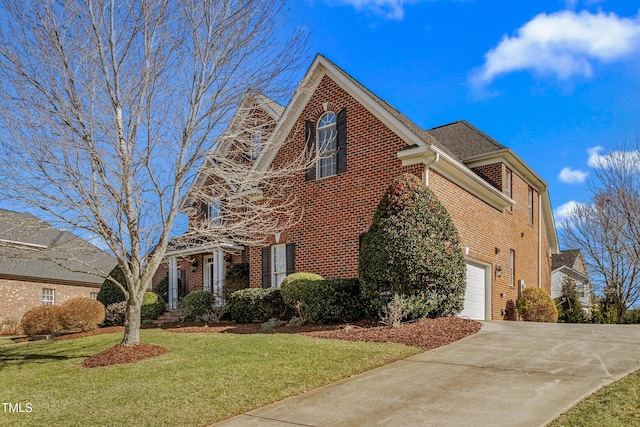 view of front of house with a garage and a front lawn