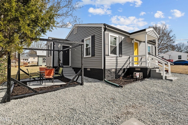 view of property exterior featuring entry steps and a patio area