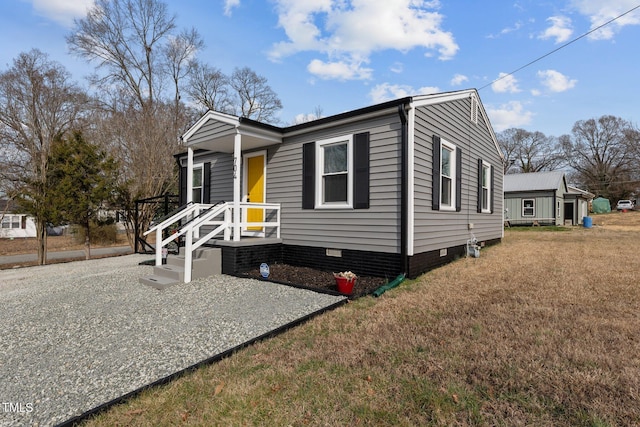 view of front of house with a front yard and crawl space