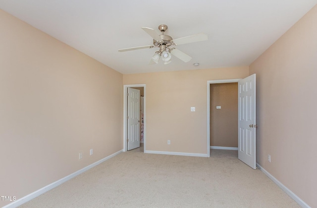 unfurnished bedroom featuring light carpet, ceiling fan, and baseboards