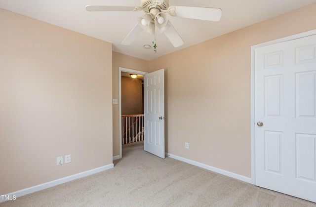 unfurnished bedroom with a ceiling fan, baseboards, and carpet flooring