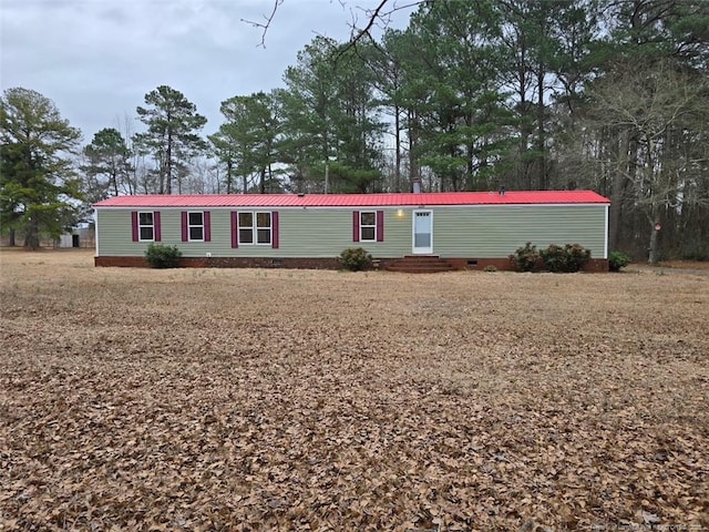 manufactured / mobile home with crawl space, metal roof, and entry steps