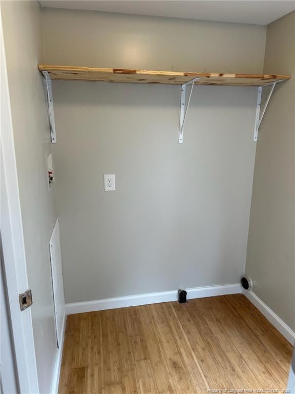 washroom with laundry area, light wood finished floors, hookup for a washing machine, and baseboards