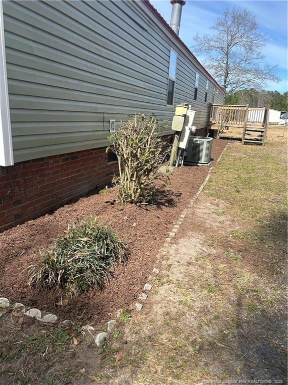 view of yard featuring central AC and a wooden deck