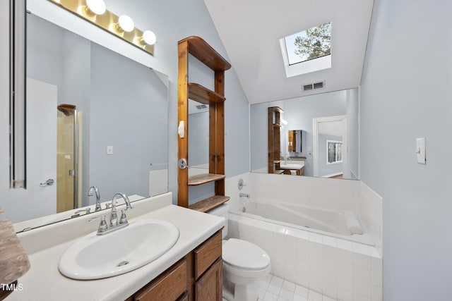 full bathroom featuring tile patterned flooring, toilet, shower with separate bathtub, vanity, and vaulted ceiling with skylight