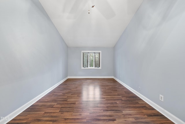 interior space featuring vaulted ceiling and dark hardwood / wood-style flooring