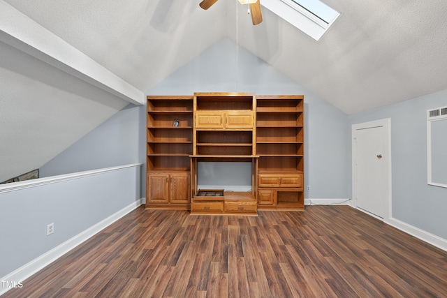 unfurnished living room with ceiling fan, dark hardwood / wood-style floors, lofted ceiling with skylight, and a textured ceiling