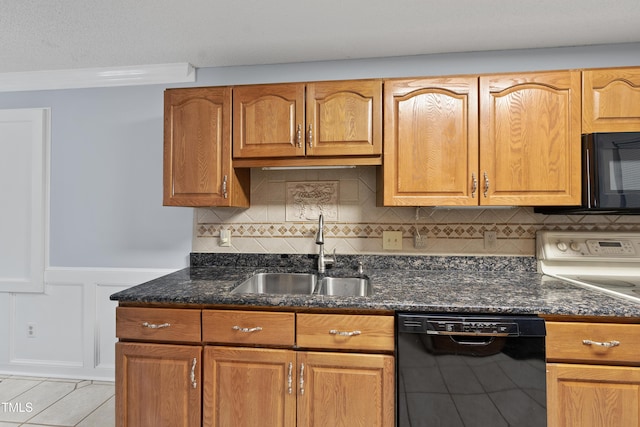 kitchen featuring sink, backsplash, dark stone countertops, and black appliances