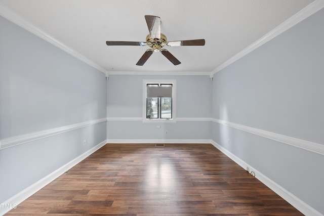 empty room with dark hardwood / wood-style flooring, ornamental molding, and ceiling fan