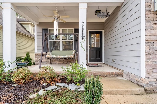 entrance to property with a porch and ceiling fan