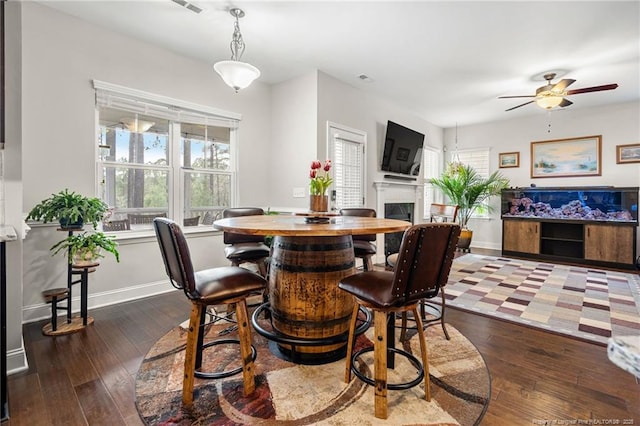 dining space featuring ceiling fan and dark hardwood / wood-style floors