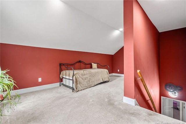 bedroom with carpet and lofted ceiling