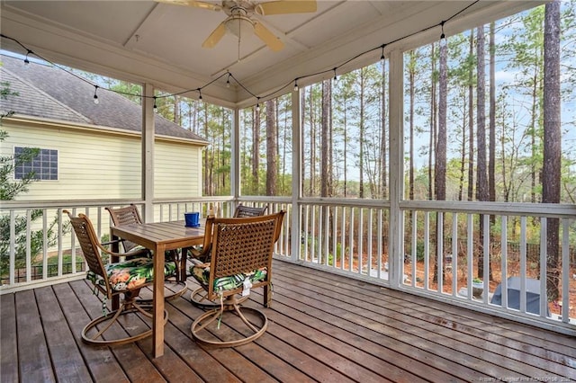 sunroom / solarium featuring ceiling fan