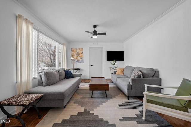 living room featuring ornamental molding, a ceiling fan, and wood finished floors