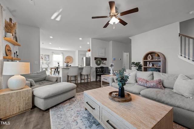 living room with hardwood / wood-style floors and ceiling fan