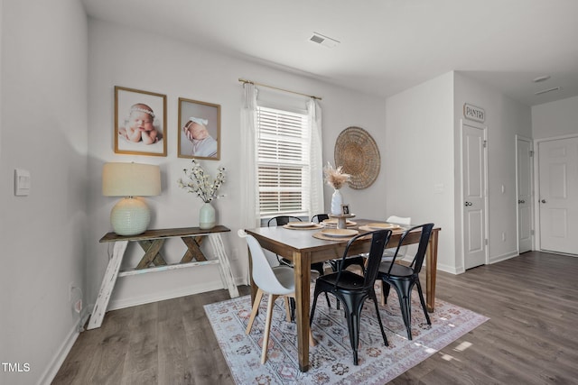 dining room with dark wood-type flooring