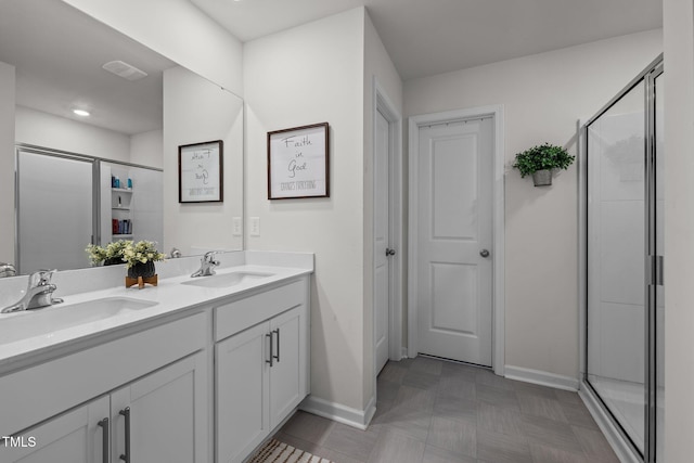 bathroom featuring walk in shower and vanity