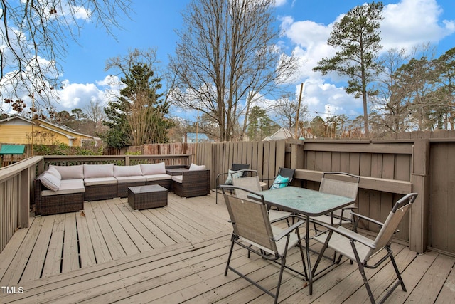 deck featuring outdoor lounge area, outdoor dining area, and fence