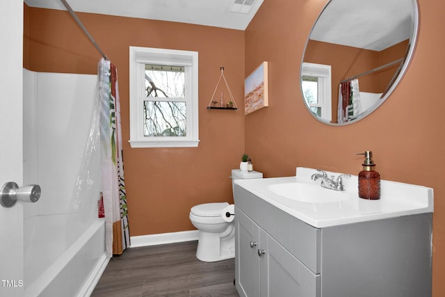 bathroom with visible vents, toilet, wood finished floors, baseboards, and vanity