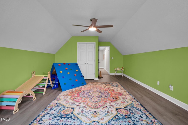 playroom featuring ceiling fan, lofted ceiling, baseboards, and wood finished floors