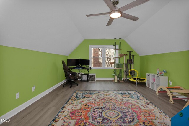 recreation room featuring vaulted ceiling, a ceiling fan, baseboards, and wood finished floors