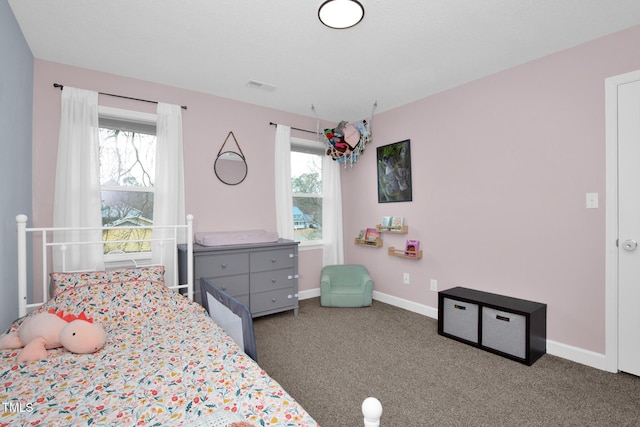 bedroom featuring visible vents, carpet floors, and multiple windows