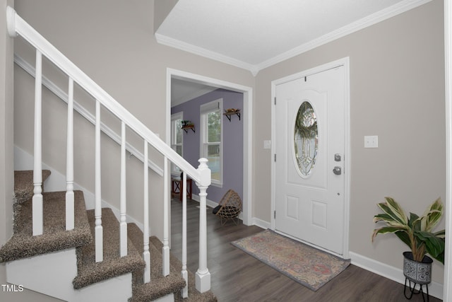 entrance foyer with stairway, dark wood-type flooring, baseboards, and ornamental molding