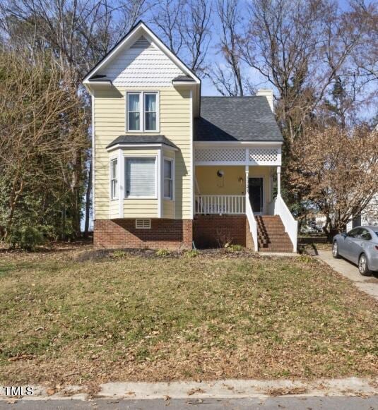 view of front of house with covered porch and a front yard