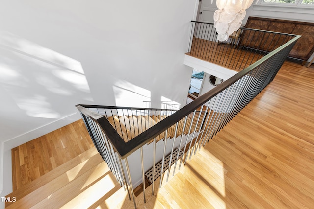 staircase with baseboards and wood finished floors