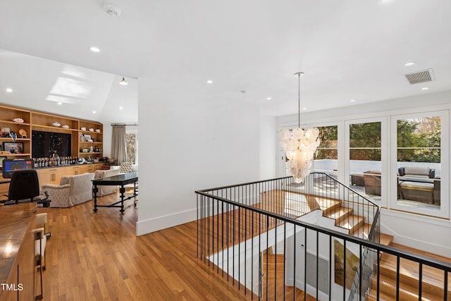 corridor featuring recessed lighting, visible vents, an upstairs landing, wood finished floors, and baseboards