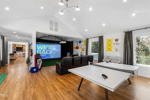 recreation room featuring lofted ceiling, light wood finished floors, visible vents, and recessed lighting