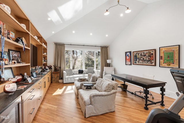 interior space with high vaulted ceiling, recessed lighting, and light wood-style floors