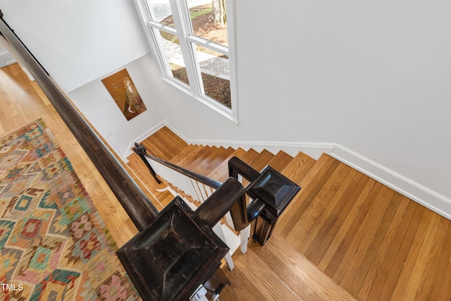 stairs featuring baseboards and wood finished floors