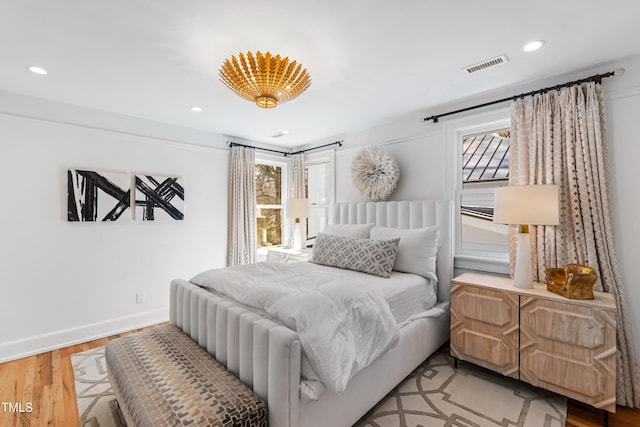 bedroom with multiple windows, recessed lighting, visible vents, and light wood-style floors