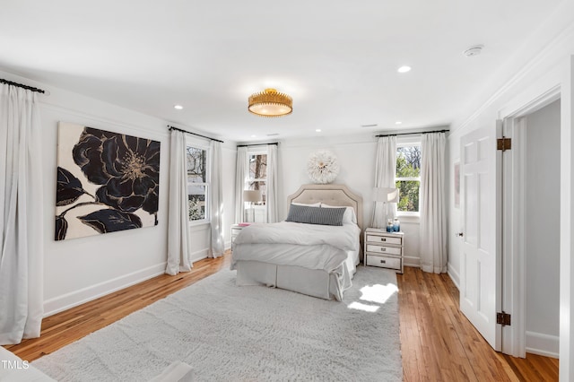 bedroom with recessed lighting, baseboards, and wood finished floors