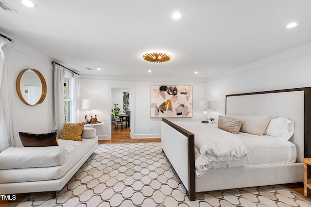 bedroom with visible vents, ornamental molding, wood finished floors, and recessed lighting