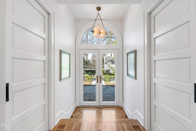 doorway to outside with visible vents, baseboards, and french doors