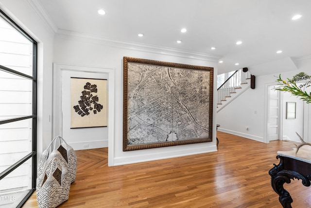 interior space featuring baseboards, recessed lighting, wood finished floors, and crown molding