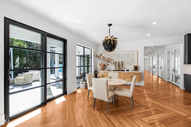 dining space with recessed lighting and an inviting chandelier