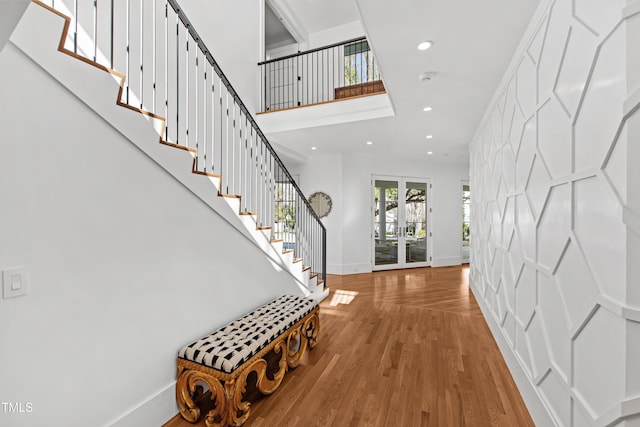 entrance foyer featuring stairs, baseboards, wood finished floors, and recessed lighting