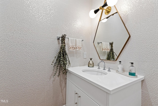 bathroom with vanity and a textured wall