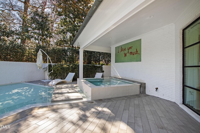 wooden deck with a jacuzzi and fence