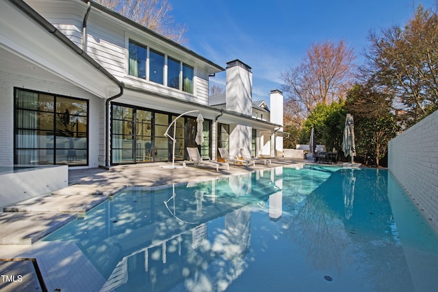 view of swimming pool with fence, a fenced in pool, and a patio