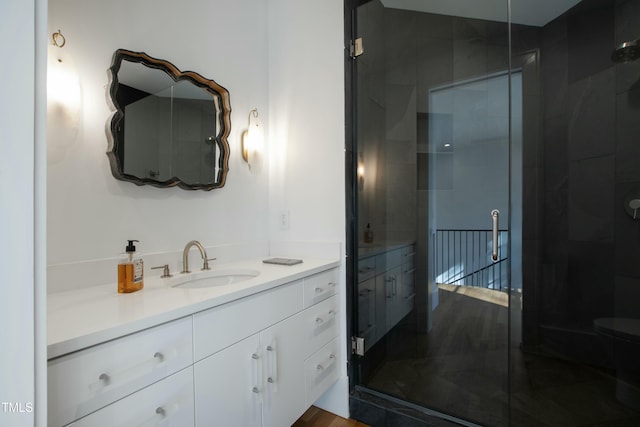 bathroom featuring a shower stall and vanity