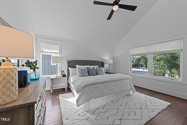 bedroom with dark hardwood / wood-style flooring, lofted ceiling, and ceiling fan